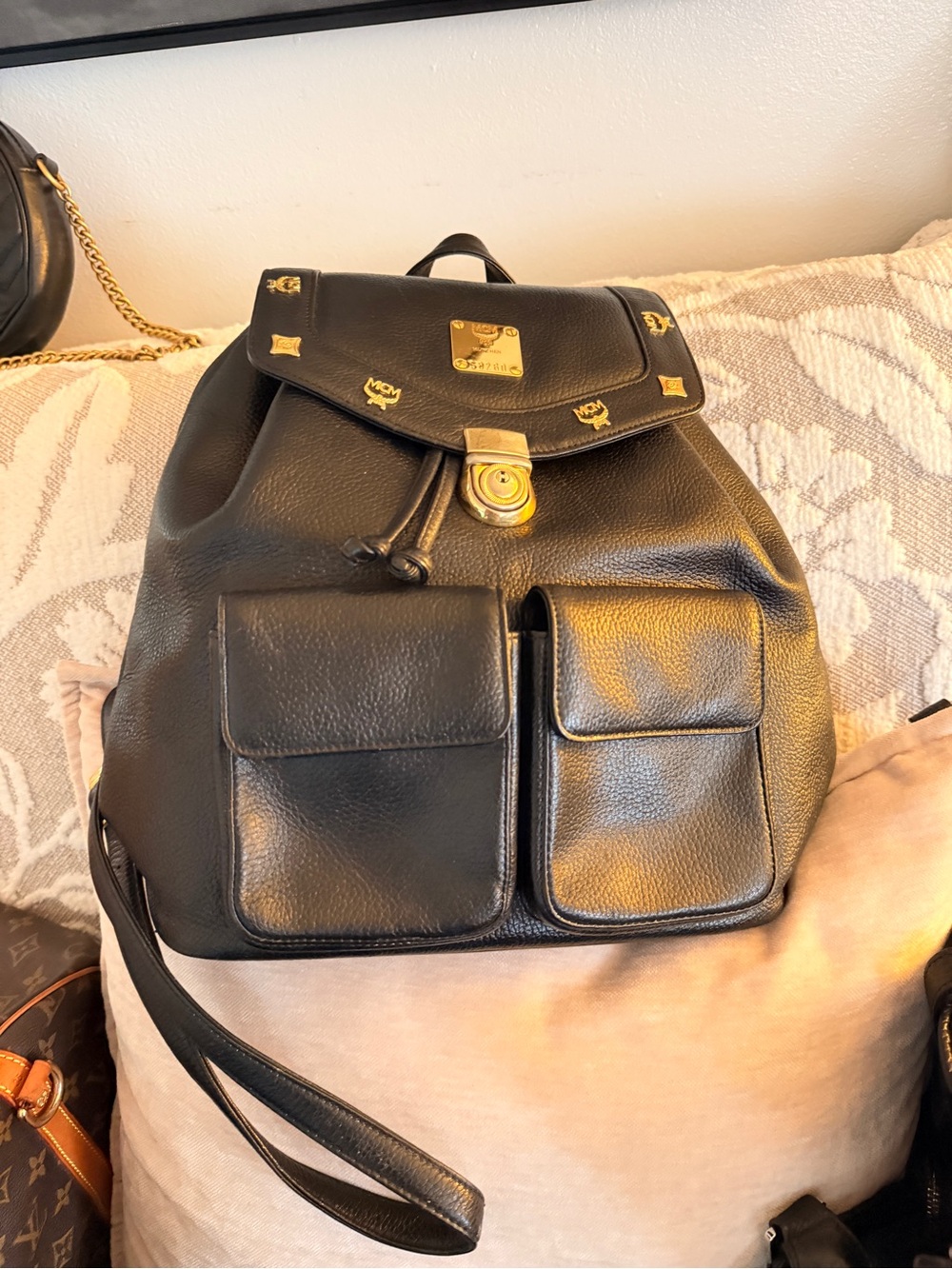 MCM Black Leather Backpack with Gold Accents and Front Pockets